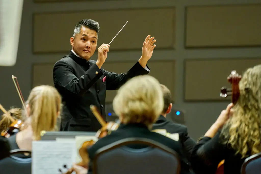 Hendersonville Symphony conductor conducting during a show